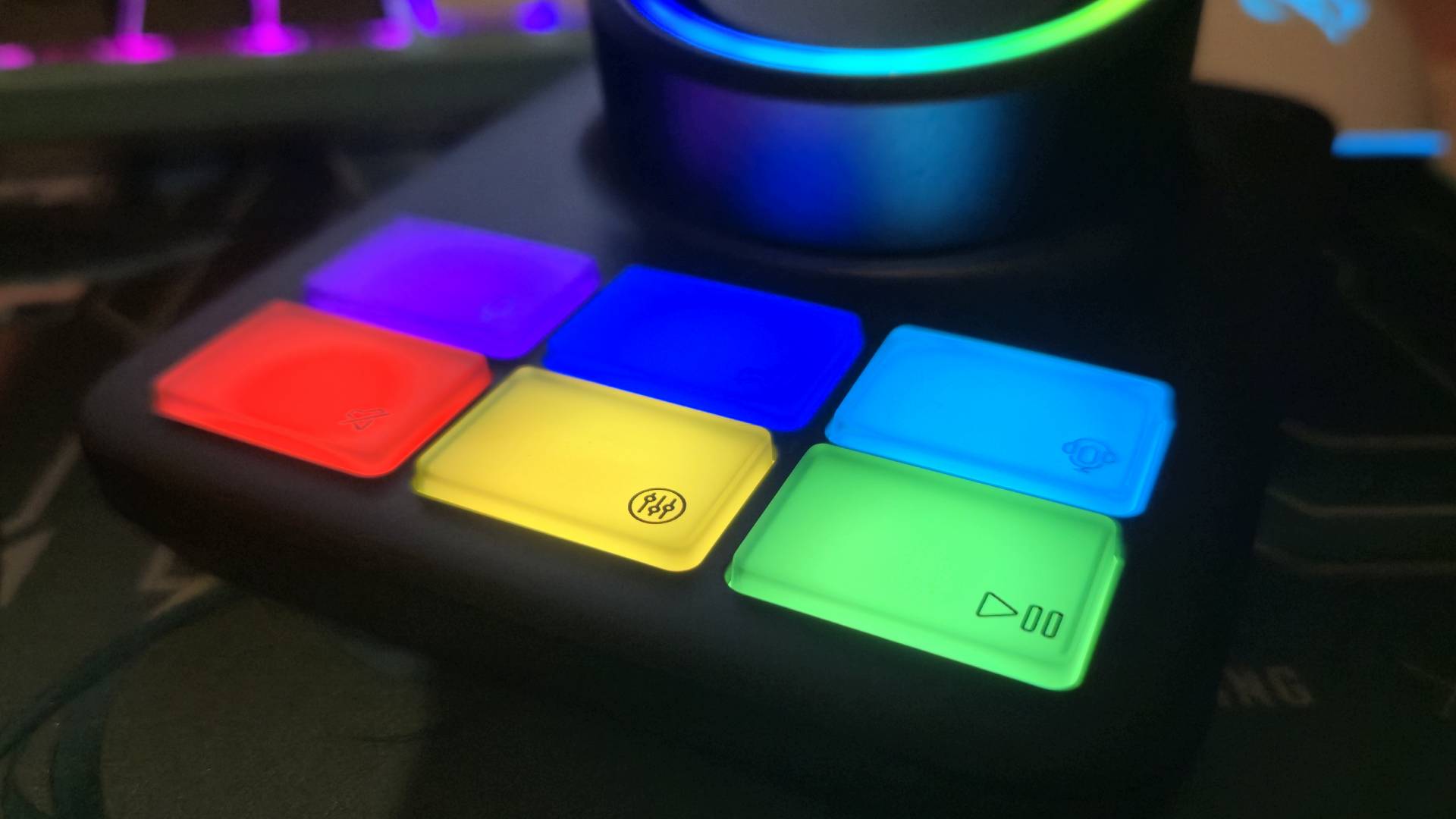 Close up of the lit-up RGB buttons of the base station of the HyperX Cloud Alpha 2 Wireless headset.