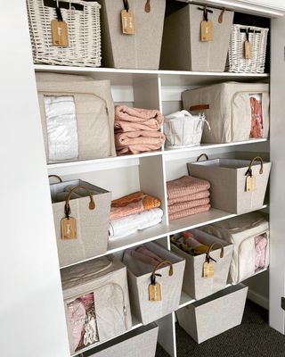 A linen cupboard with multiple organization boxes