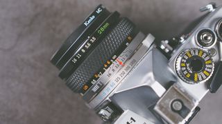 Top down view of an Olympus OM1 film camera with a 28mm lens