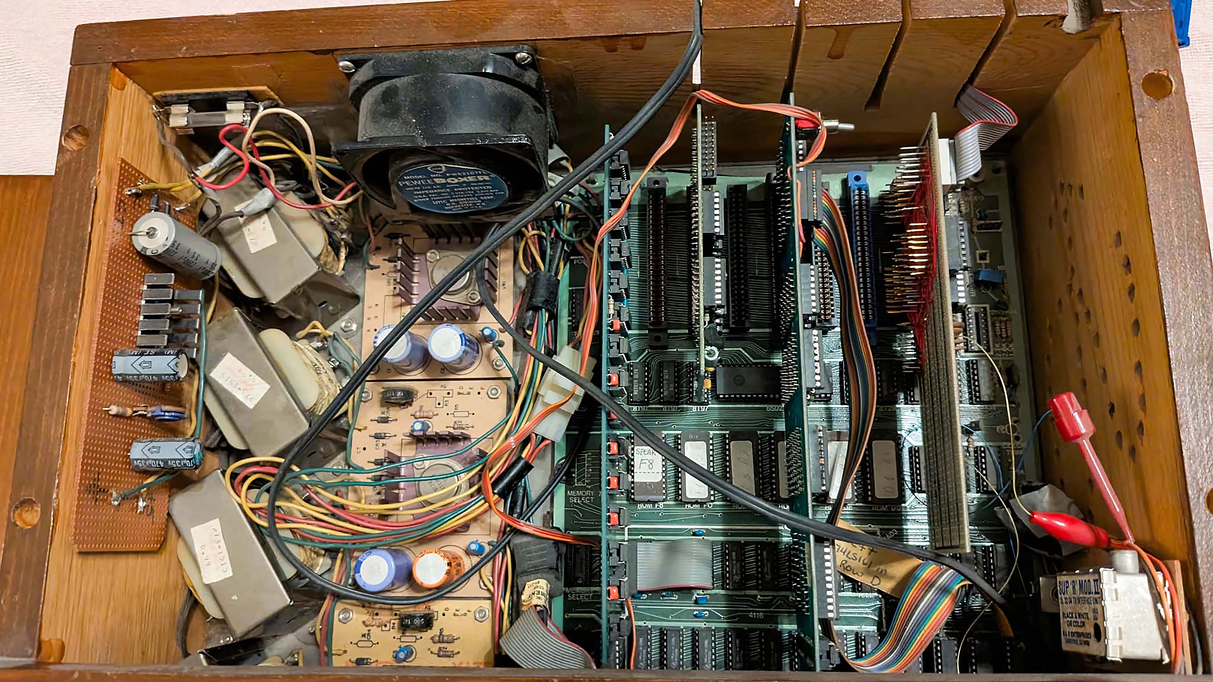 A customized computer built in 1982 with the lid open to view its various computer parts.