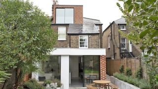 loft conversion with brick cladding on exterior matching extension below