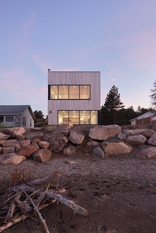 view of seaside boxy timber house in Canada from the water