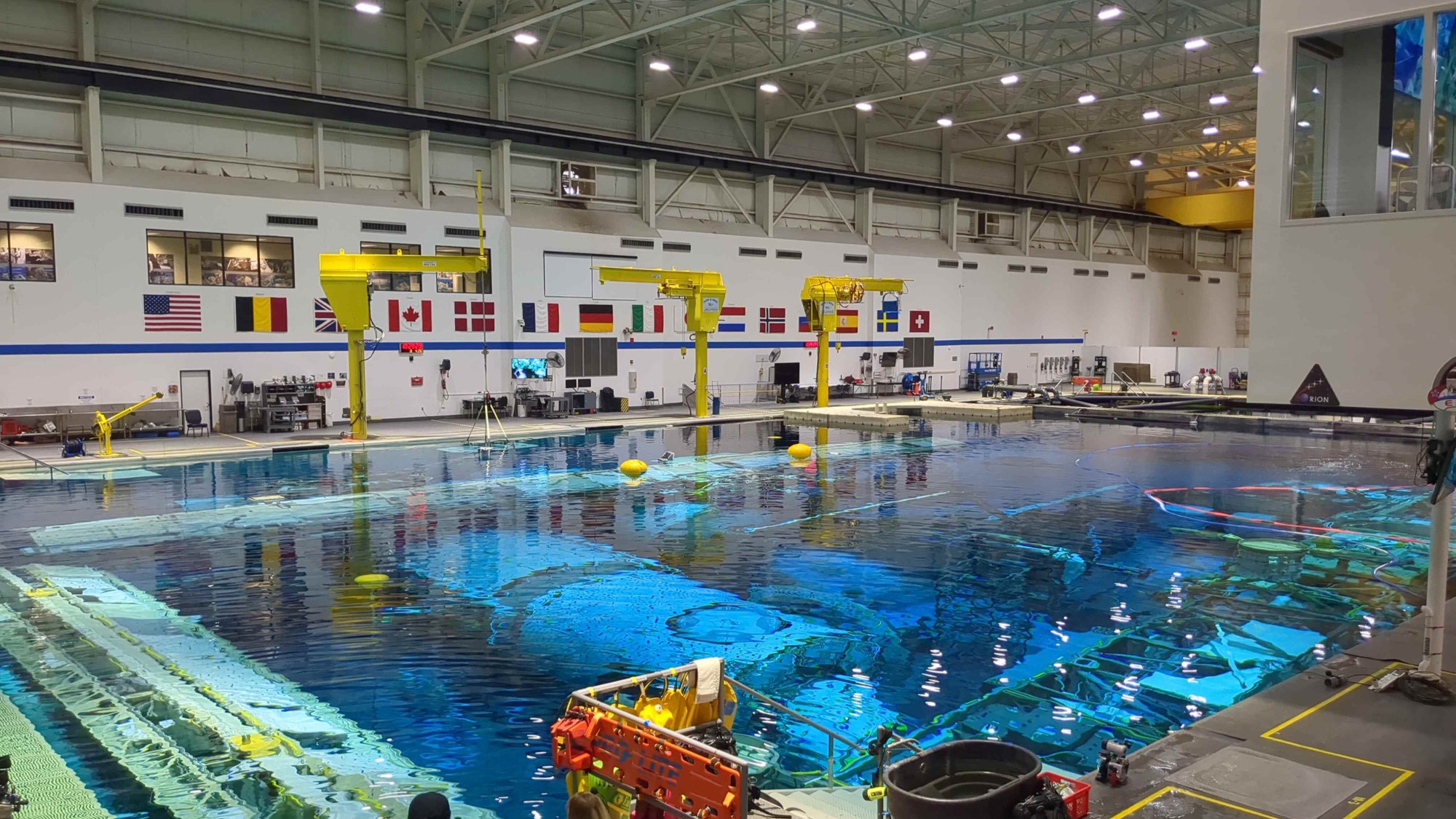 a large swimming pool inside a hangar-like building