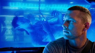 Sam Worthington sits in front of his Na'vi tank in Avatar.