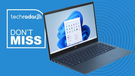 The Walmart-exclusive HP 14-inch laptop on a blue background next to a white TechRadar badge in the upper left that reads 'Don't Miss'