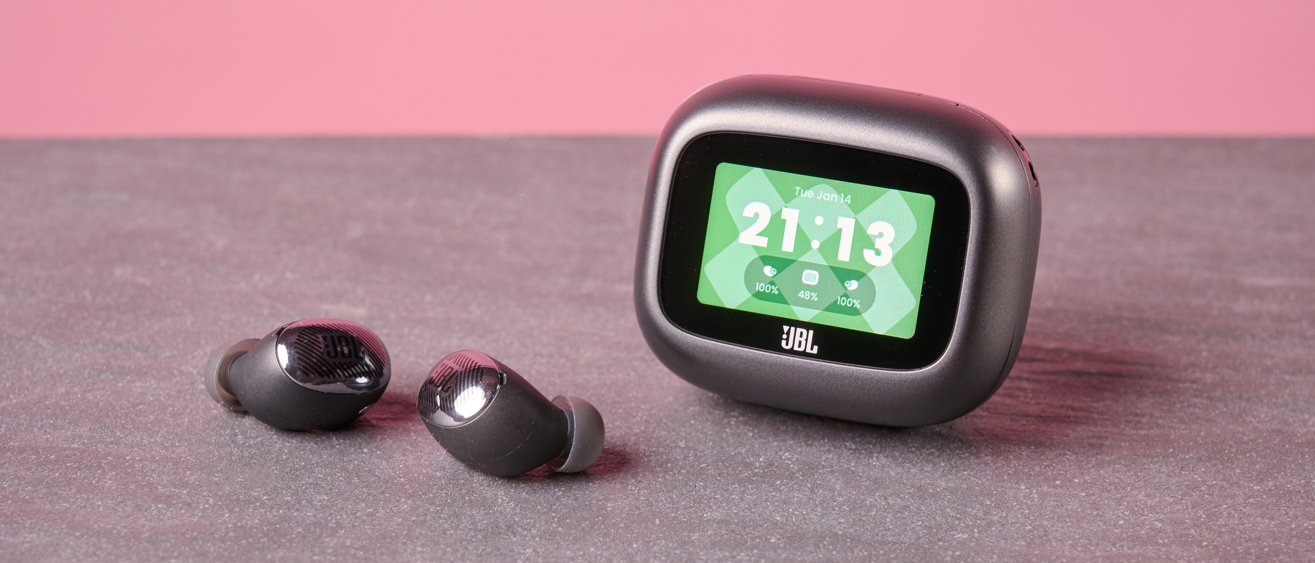 JBL Live Buds 4 on table with display on