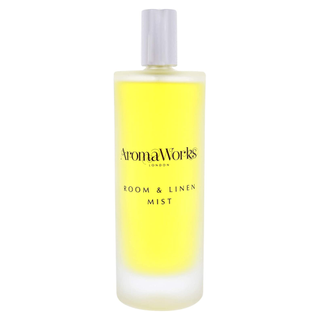 A bottle of yellow Aromaworks room and linen spray
