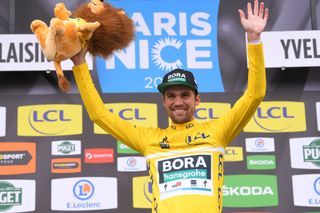 Max Schachmann pulls on the leader's yellow jersey at Paris-Nice