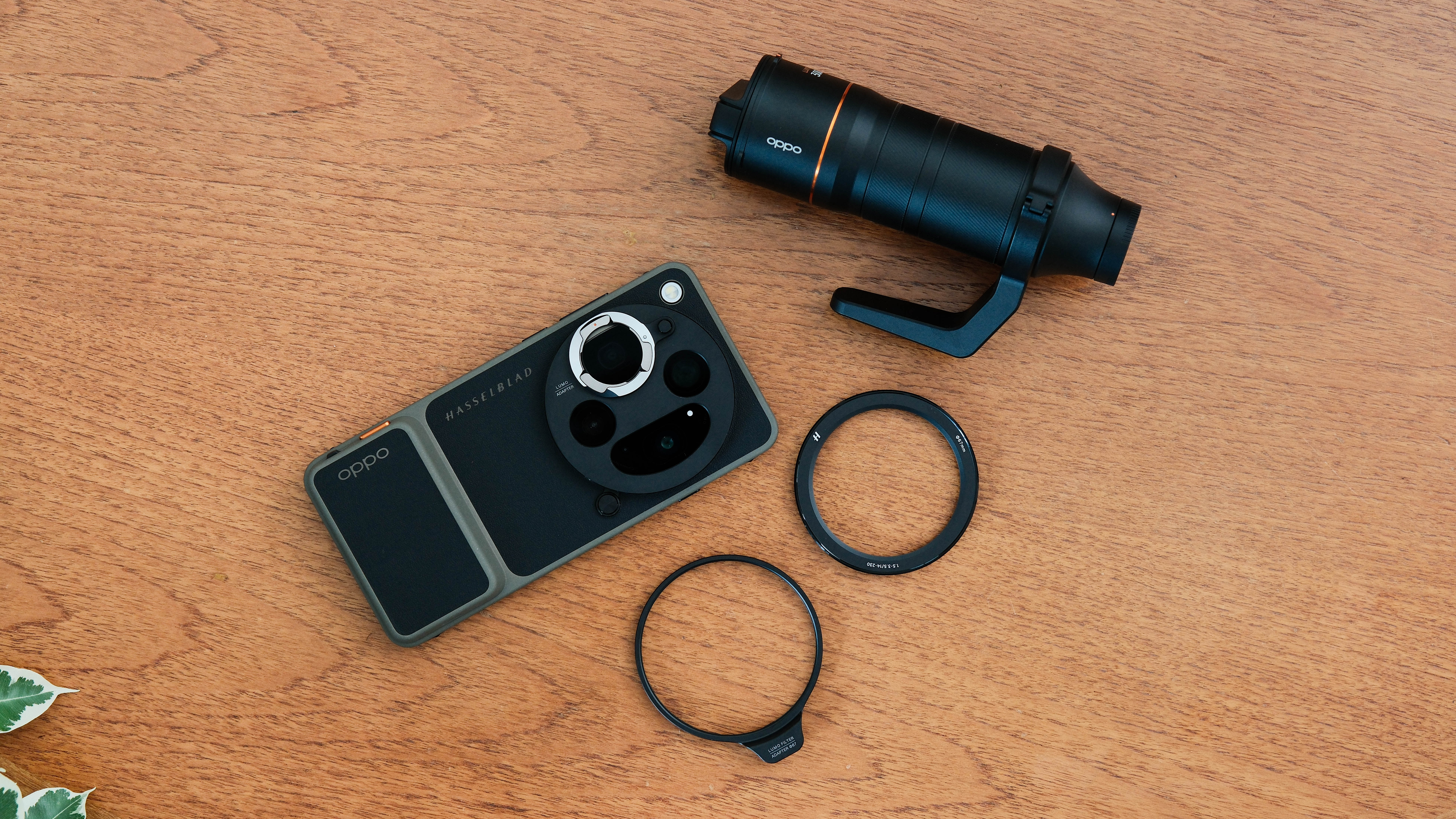 Oppo Find X9 Ultra photography accessories laid out on a wooden table