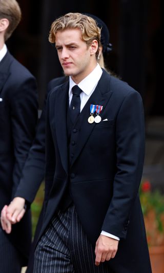 Alexander Ogilvy wearing a suit and medals at the funeral of Queen Elizabeth