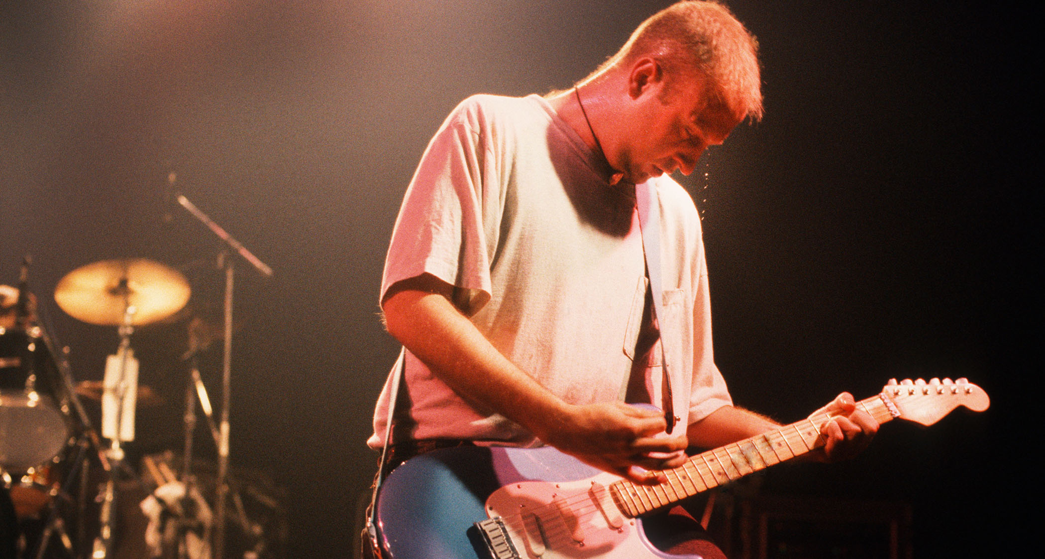 Bob Mould wears a gray T-shirt and plays his blue Stratocaster live with Sugar in 1992