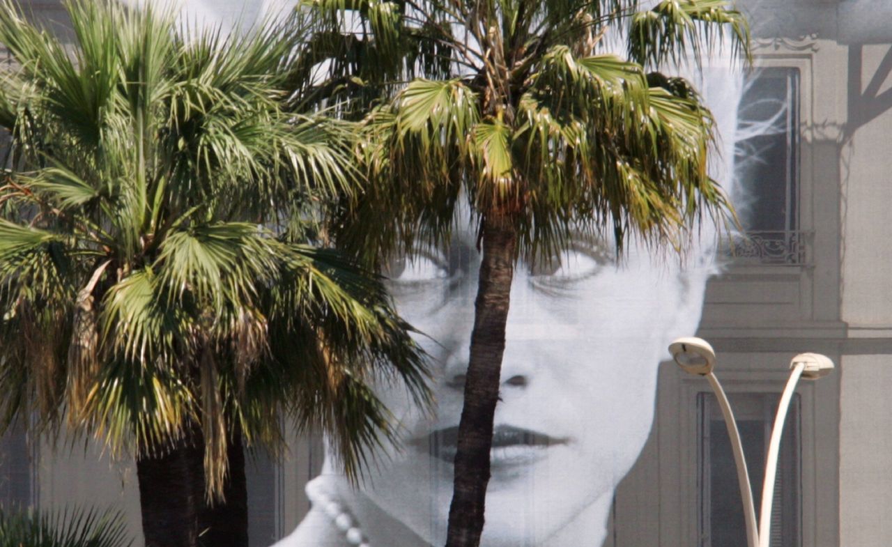 Actor Patricia Arquette’s face peeps from behind palm trees during a past edition of the Cannes International Film Festival