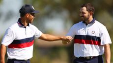 Xander Schauffele and Patrick Cantlay fist-bump at the 2023 Ryder Cup during a foursomes match