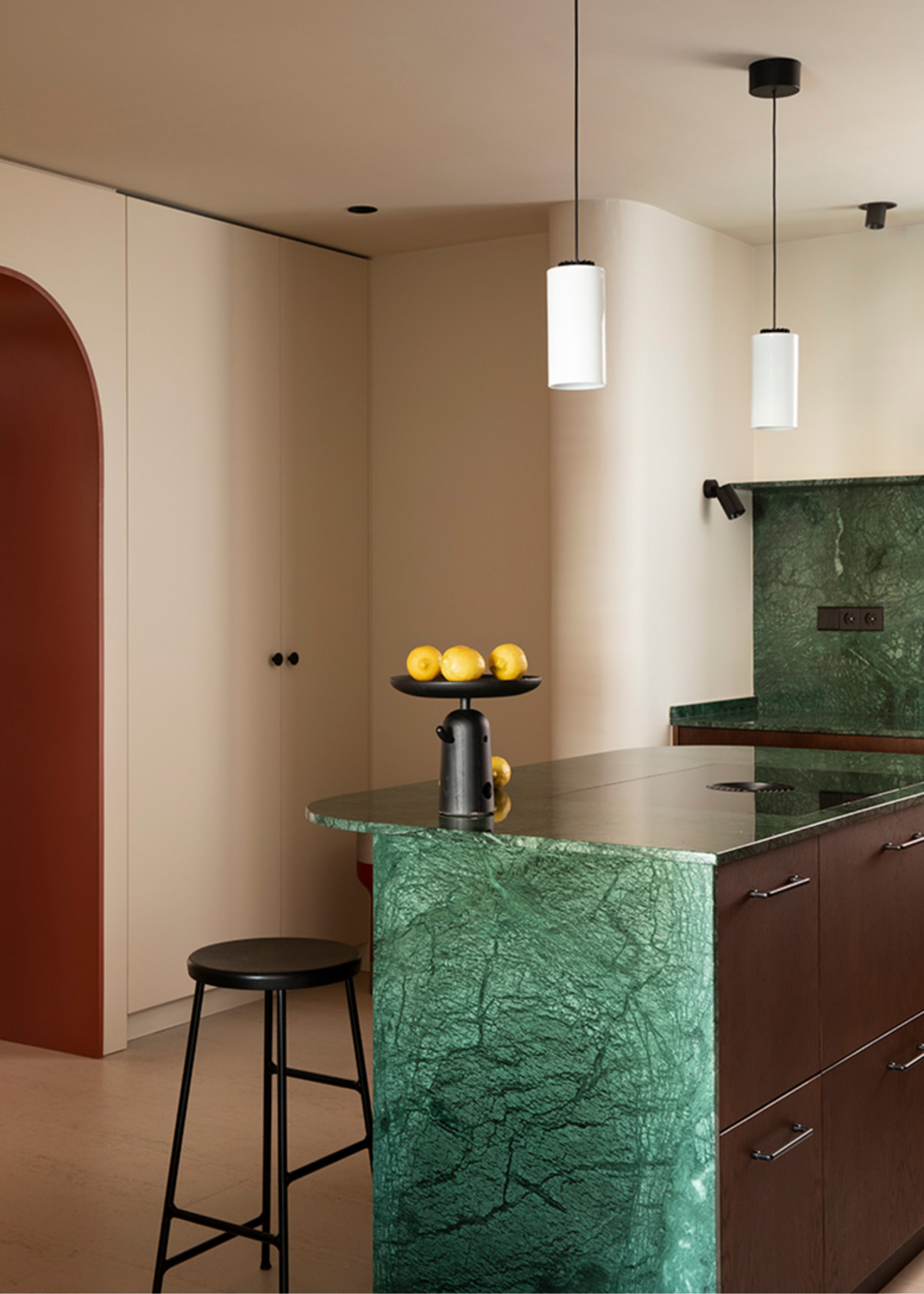 A kitchen with a green marble island and countertop