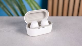 LG xboom Buds photographed in front of a blue background.