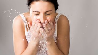 woman wash face properly