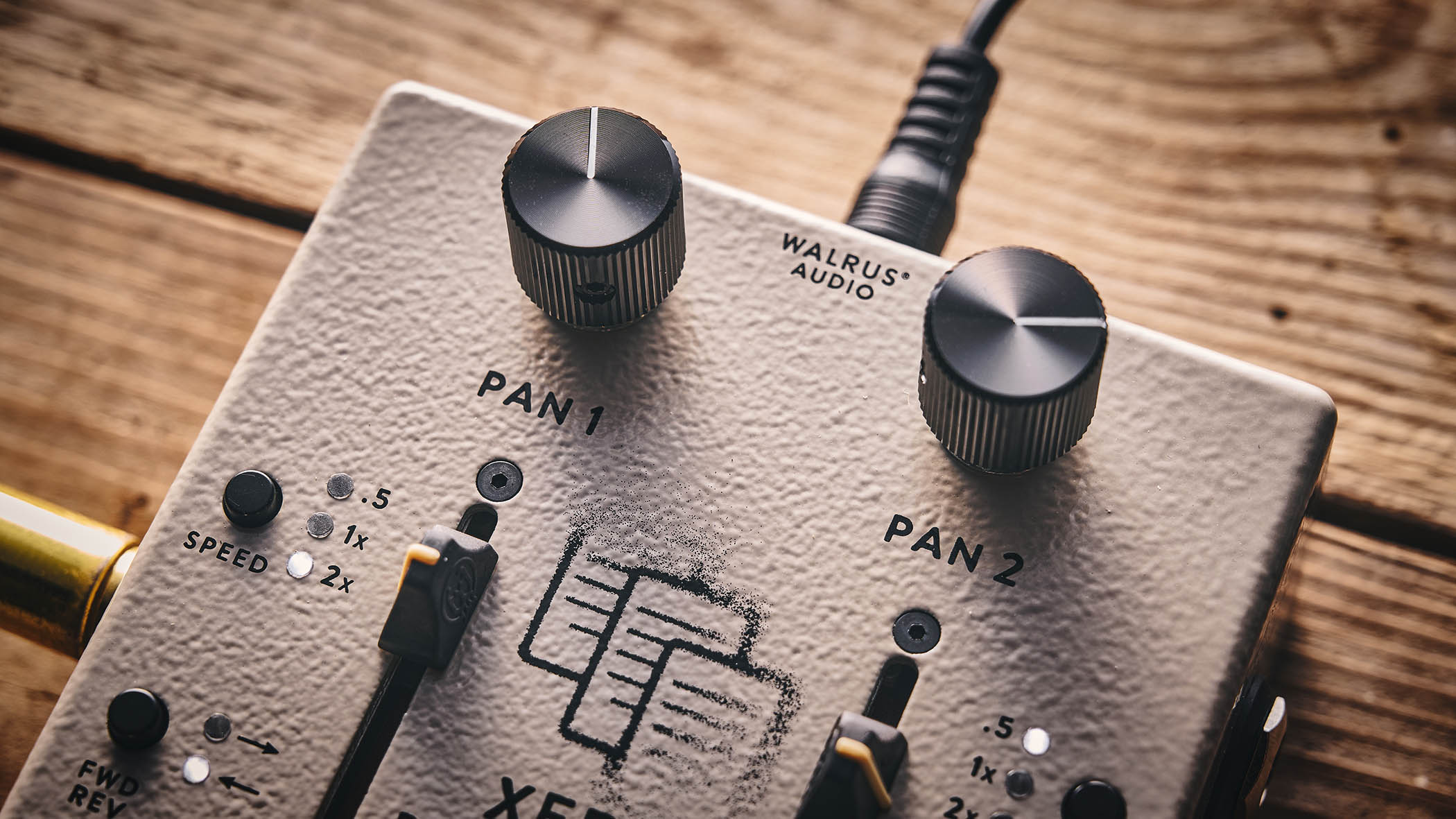 Walrus Audio Xero Polylooper: the dual-slider and footswitch looper is photogaphed against a wooden floor.