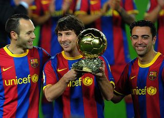 Barcelona's Argentinian forward Lionel Messi (C), flanked with Barcelona's midfielder Xavi Hernandez (R) and Barcelona's midfielder Andres Iniesta (L), poses with the 2010 Ballon d'Or trophy (Golden Ball) for the best European footballer of the year prior to the Copa del Rey (King's Cup) football match FC Barcelona vs Real Betis on January 12, 2011 at the Camp Nou stadium in Barcelona. AFP PHOTO/ LLUIS GENE (Photo credit should read LLUIS GENE/AFP via Getty Images)