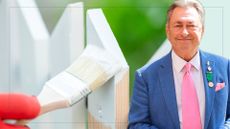 picture of garden fence being coloured white with cut out of alan titchmarsh over top