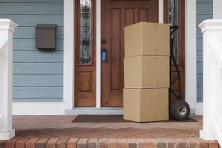 Three boxes being delivered on a stoop