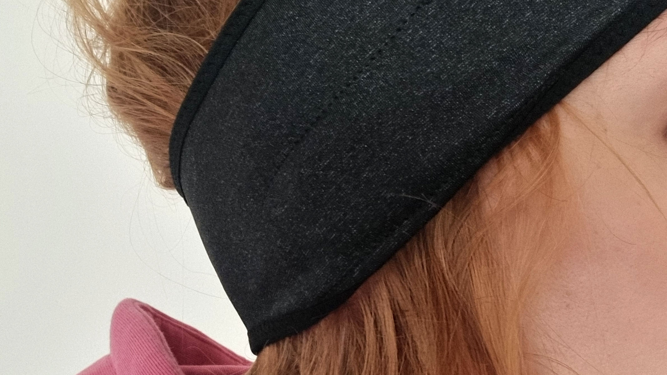 A close-up picture of our reviewer wearing the Musicozy Sleep Headphones
