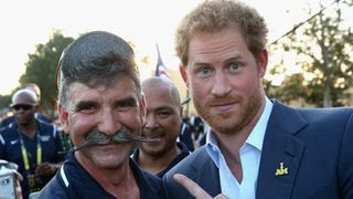 Prince Harry and a man with a moustache
