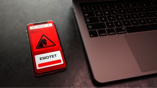 3D illustration of the emotet botnet triggering an alert on a smartphone positioned next to a laptop