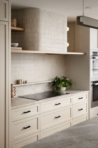 kitchen in neutral tones with shelf above hob