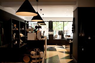 The interior of a store featuring monochrome interior designs and long glass panels