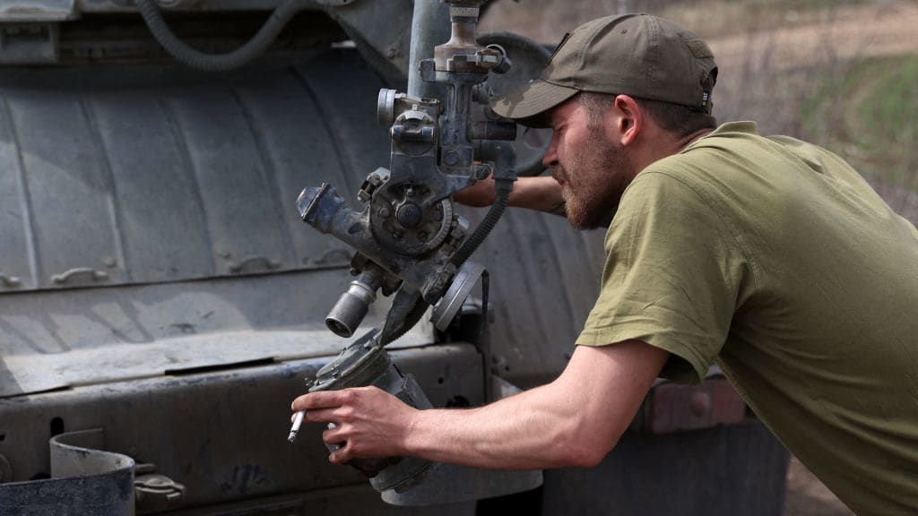 A Ukrainian artilleryman prepares a multiple rocket launcher.