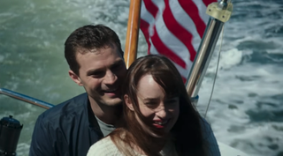 Jamie Dornan and Dakota Johnson driving boat in Fifty Shades Darker