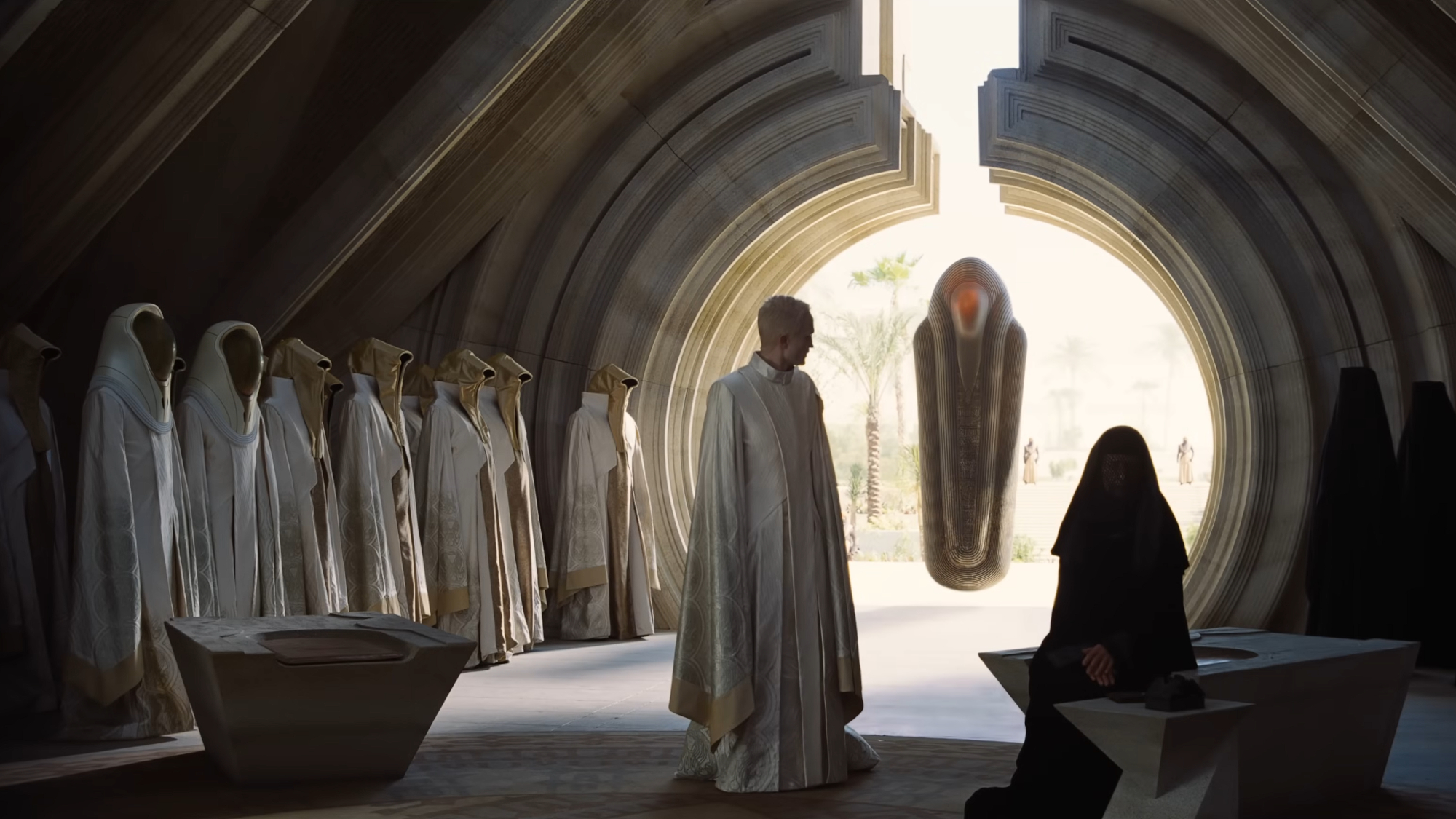 a group of robe humans in a sci-fi movie