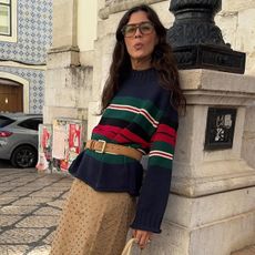 Woman in stripe sweater and skirt