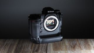 Nikon Z9 camera on a wooden surface in front of a black wall