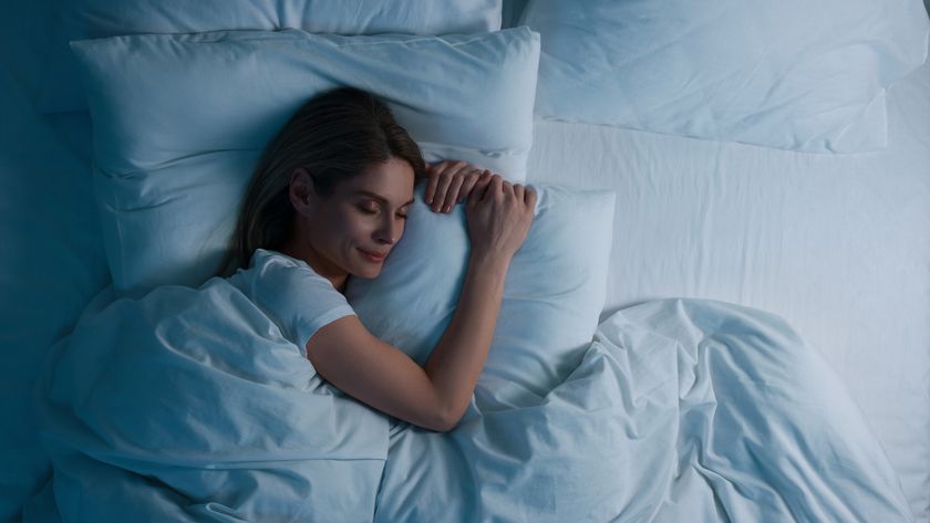 A woman with long dark hair falls asleep fast in bed