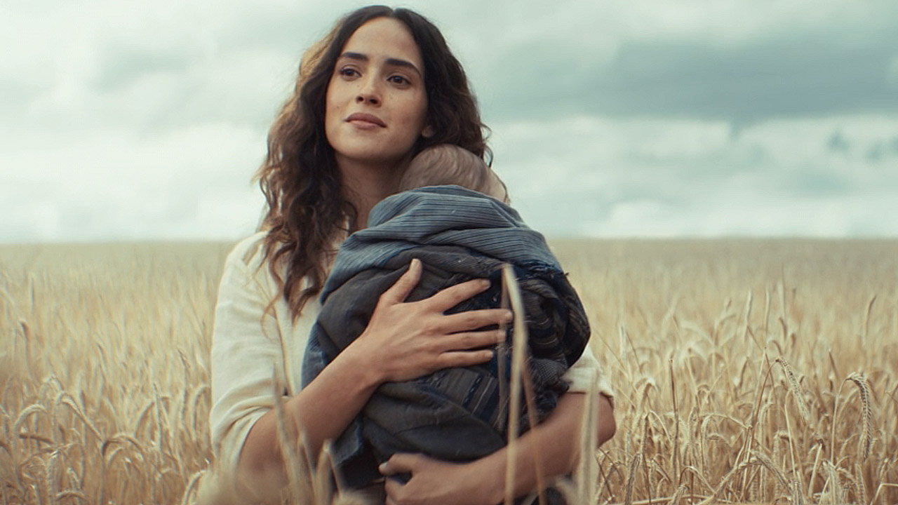 Bix smiling as she cradles her and Cassian's child in Andor season 2 episode 12
