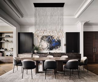 Grey and white dining chairs, wooden dining table, black cabinets