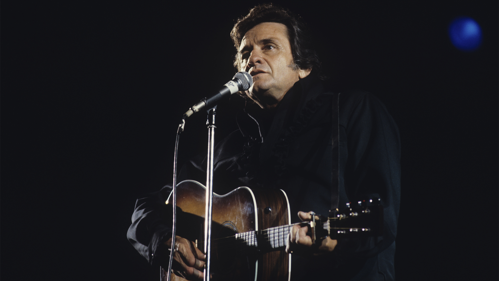 Johnny Cash performs on stage at the Country Music Festival held in Portsmouth, England on August 10, 1980. 