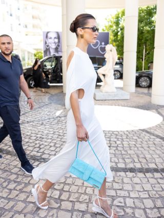 Bella Hadid wears a white jacquemus t shirt dress with a jacquemus bag in france