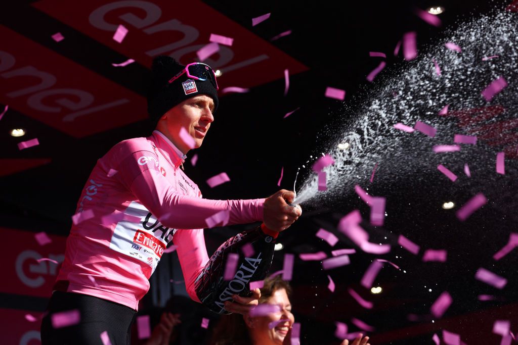 Pink jersey, Team UAE's Slovenian rider Tadej Pogacar celebrates on the podium after winning the 8th stage of the 107th Giro d'Italia cycling race, 152km between Spoleto and Prati di Tivo, on May 11, 2024. (Photo by Luca Bettini / AFP)