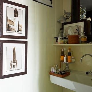 bathroom with wash basin and frame on wall