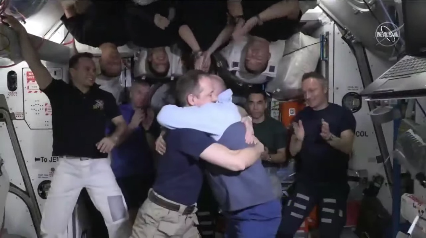 NASA astronaut Thomas Marshburn (left) hugs Oleg Artemyev shortly after handing command of the International Space Station over to the cosmonaut on May 4, 2022.