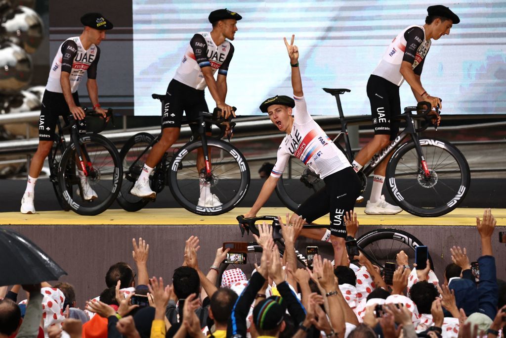 UAE Team Emirates Slovenian rider Tadej Pogacar C flashes a victory sign as he exits the stage during the official teams presentation near the Guggenheim Museum Bilbao in Bilbao northern Spain on June 29 2023 two days prior to the start of the 110th edition of the Tour de France cycling race Photo by AnneChristine POUJOULAT AFP Photo by ANNECHRISTINE POUJOULATAFP via Getty Images
