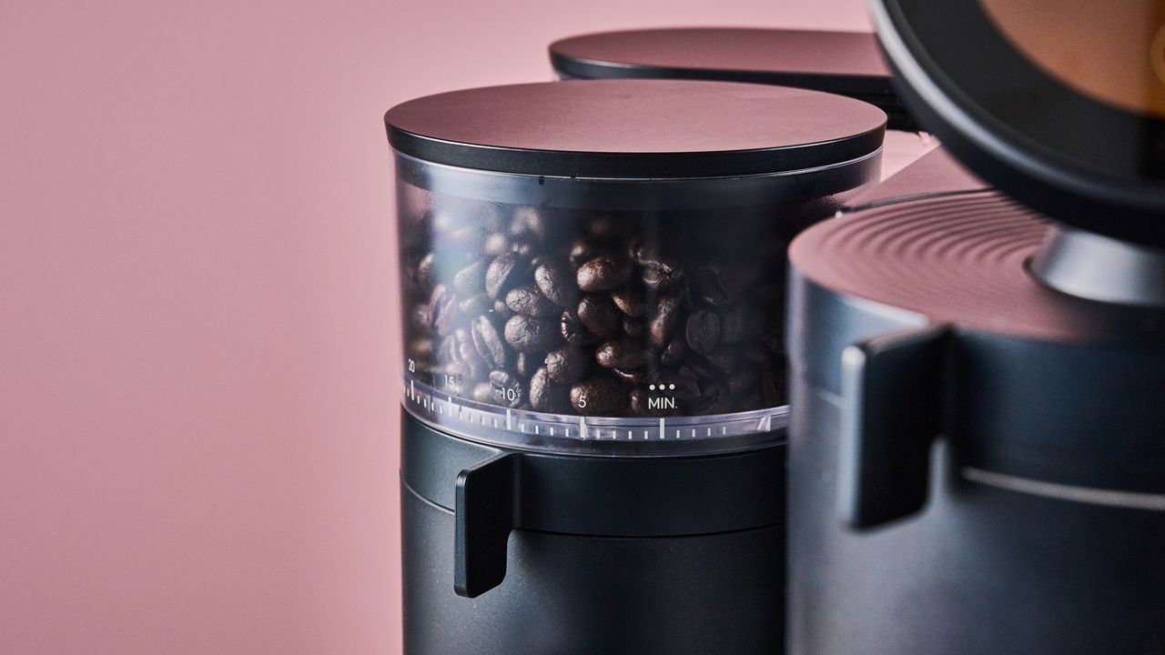 A closeup of the Meraki Espresso Machine's grinder full of beans.