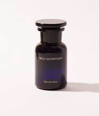 Wild Nutrition Natural Glow supplements for sun protection in blue glass bottle