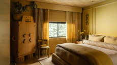 a yellow bedroom with a unique freestanding wardrobe and details