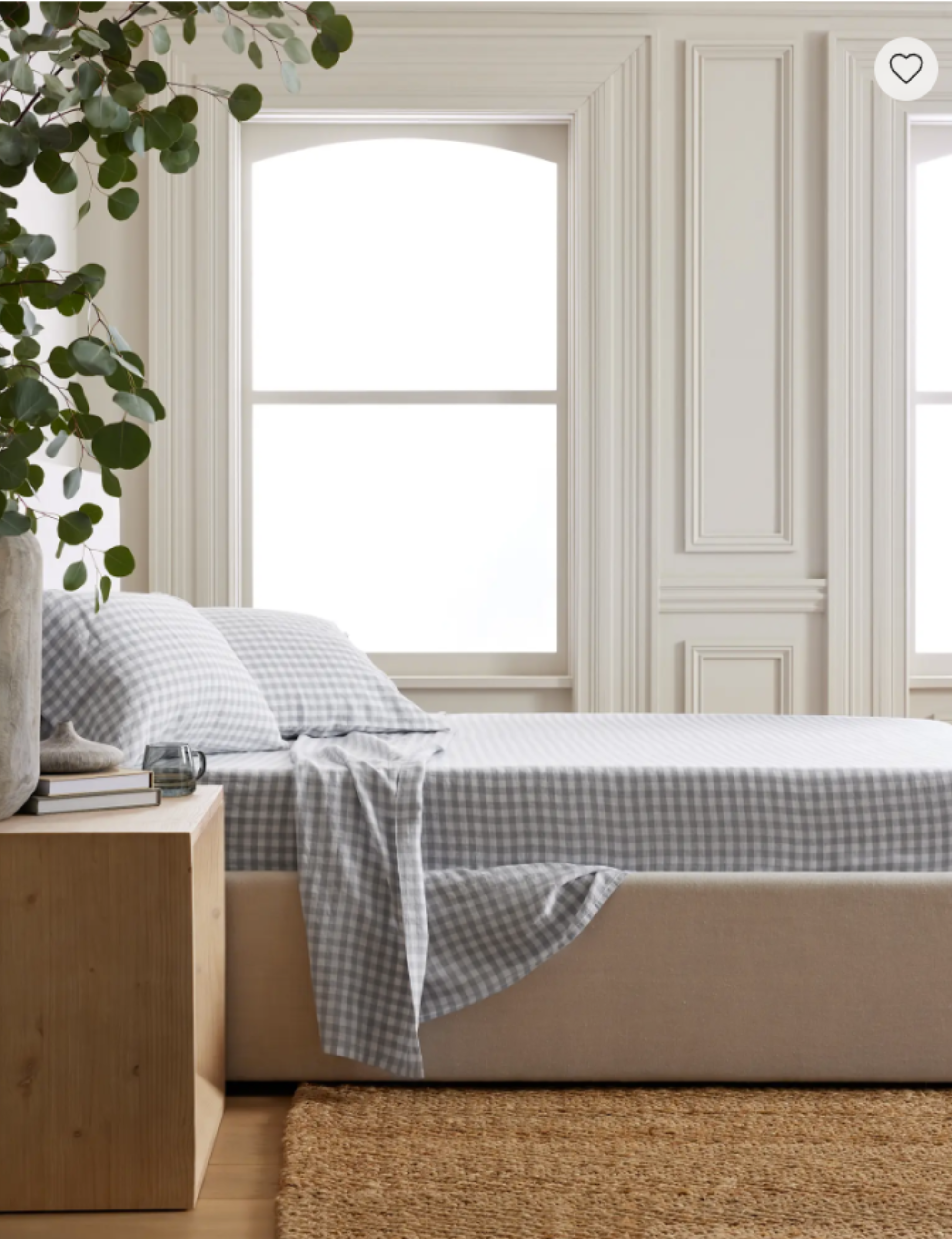 Quince blue gingham bed sheets styled inside of a bright white bedroom with decorative molding
