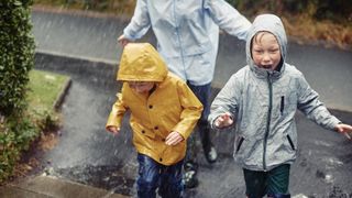 kids and parent running in rain