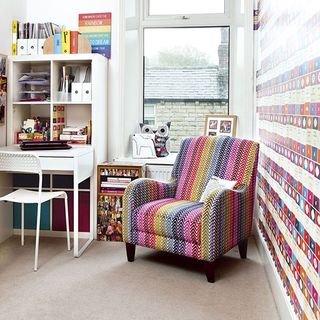 room with colourful sofa and wallpaper on wall