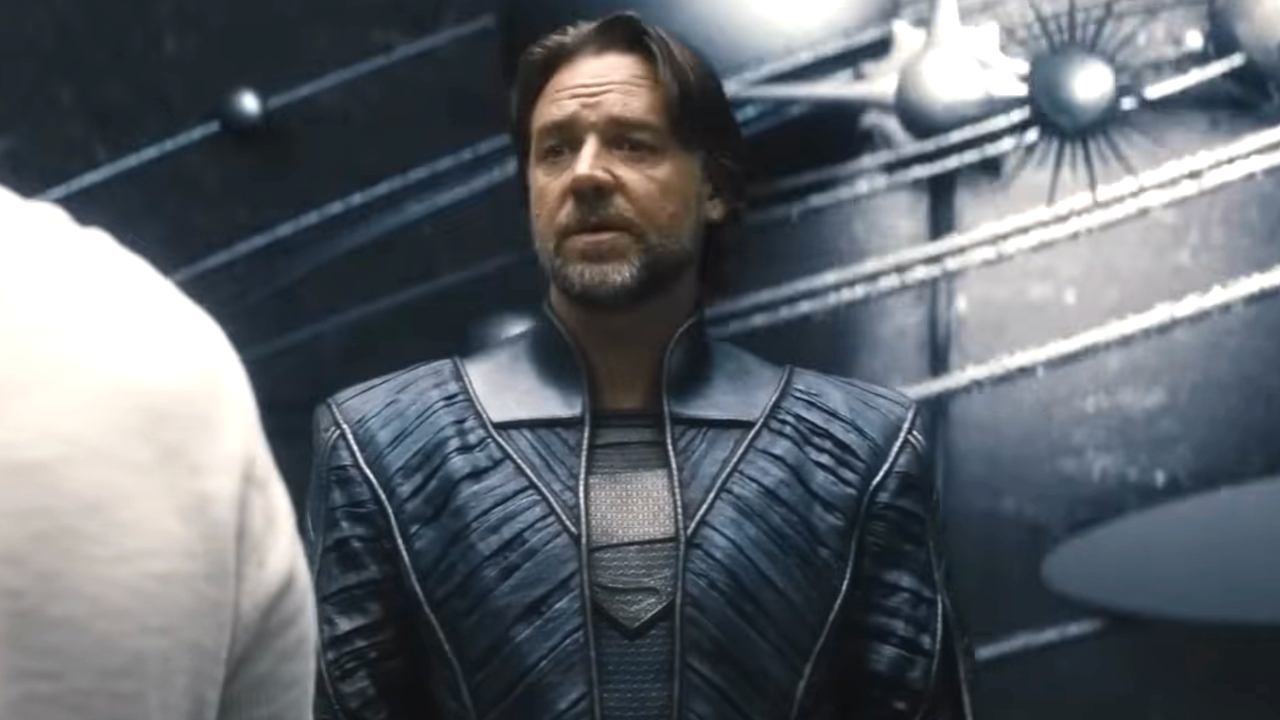 Russell Crowe stands before a mural of the universe in Man of Steel.